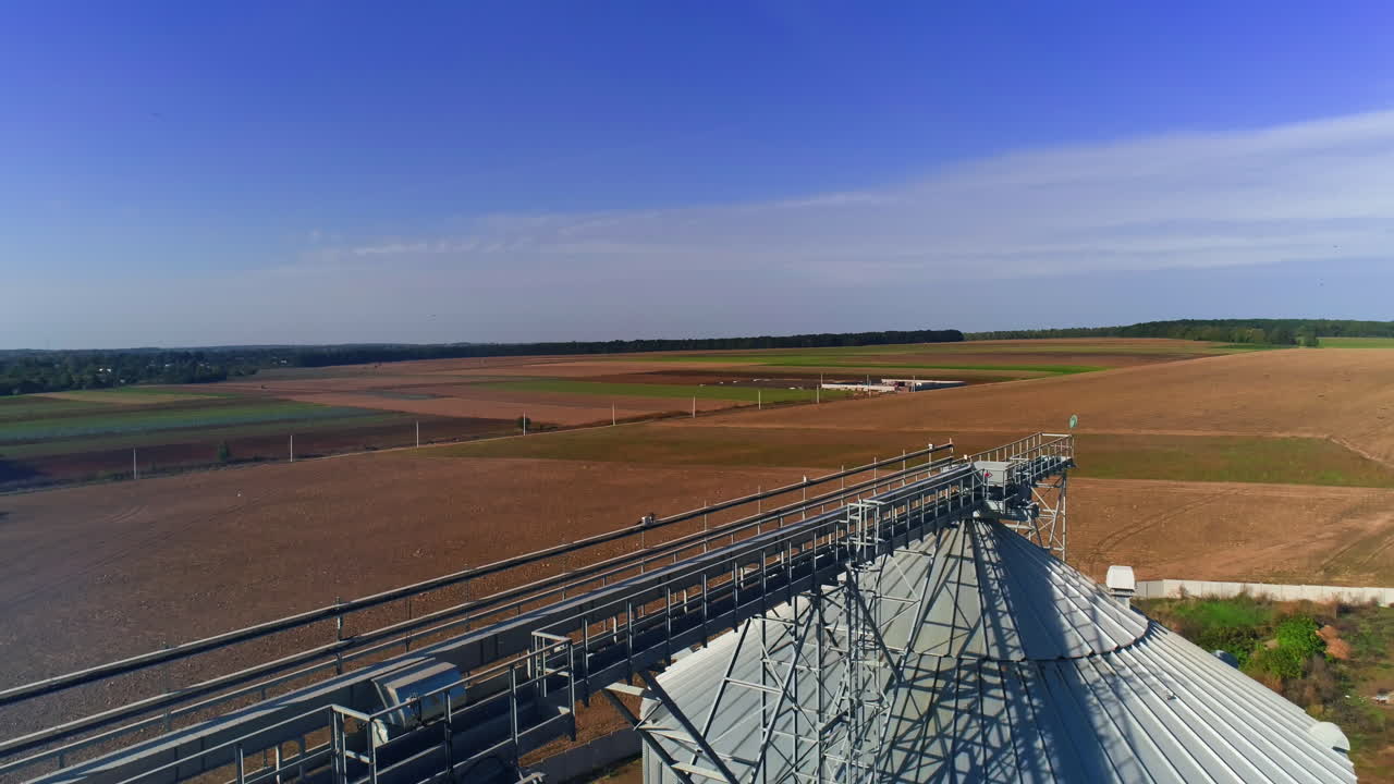 Industrial agriculture elevators with harvested grain. Grain cooperative. Video from copter on roofs.