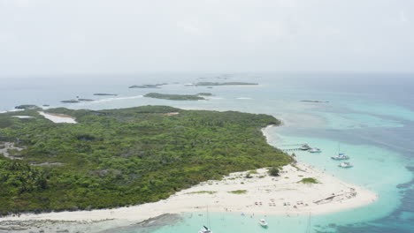 AERIAL---Turquoise-waters-and-beaches,-Cayo-Icacos,-Puerto-Rico,-high-angle-truck-left