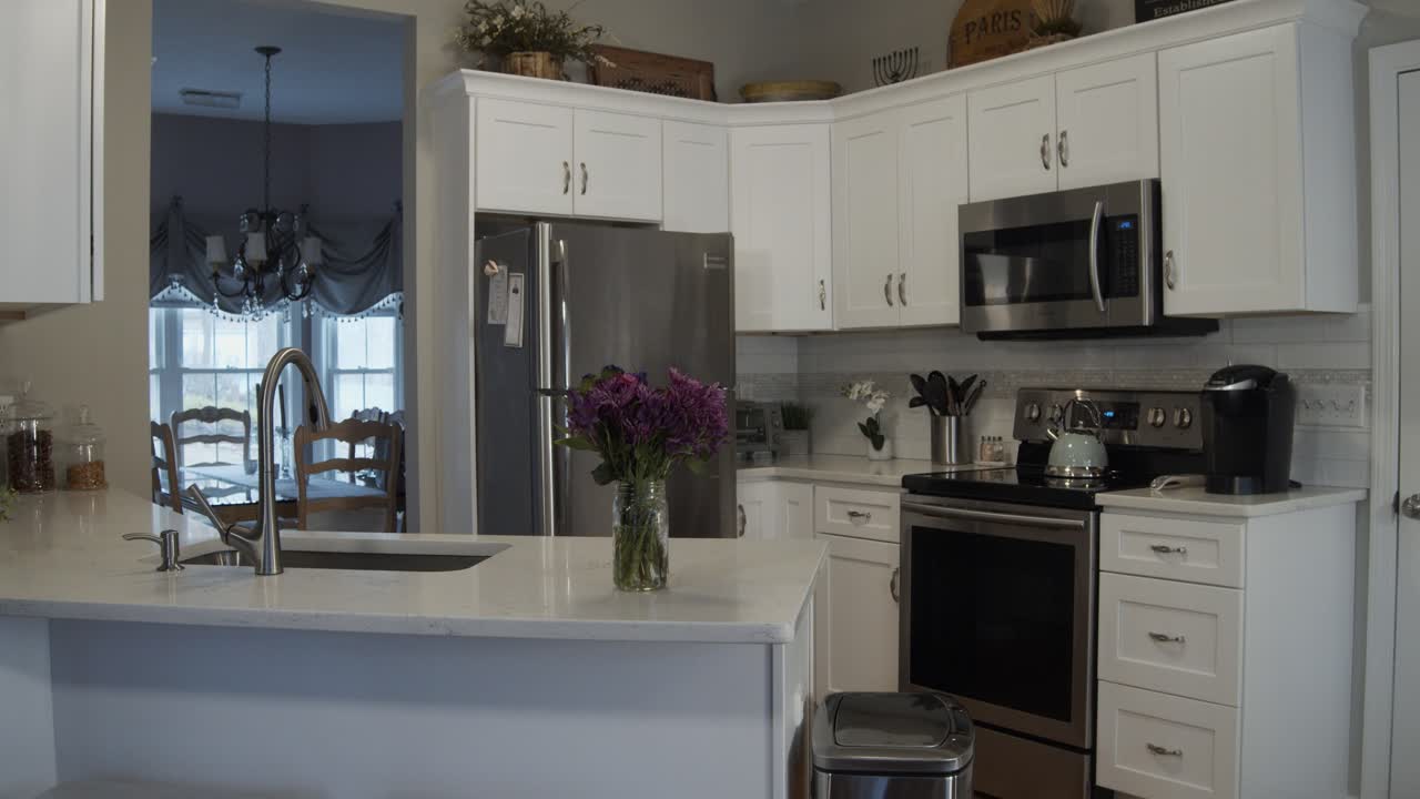 Tilt down shot of a beautiful white and clean newly remodeled luxury kitchen