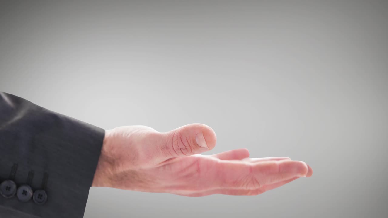 Businessman's hand with palm up dressed in grey suit on grey background