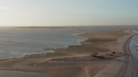 Aerial:-The-lagoon-of-Atins,-Brazil-during-sunset-with-people-kitesurfing