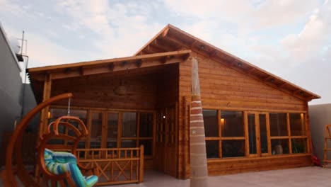 slow aerial flying backwards of newly built wooden house facade