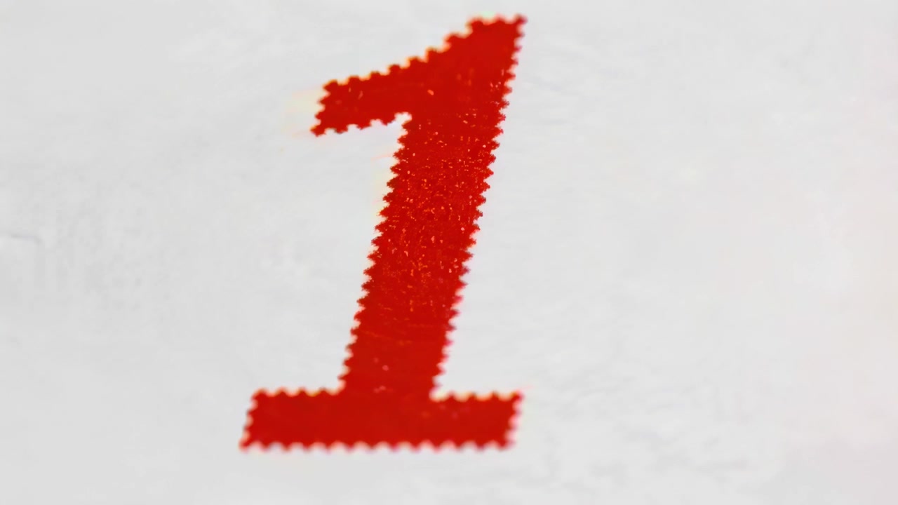 Pulling back camera from close-up, revealing red numeral 1 on textured white paper with ink texture
