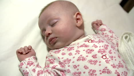 Close-Up-Of-Baby-Girl-Sleeping-In-Nursery-Cot