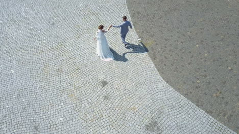 aerial view. wedding couple walks on old european city street. just married
