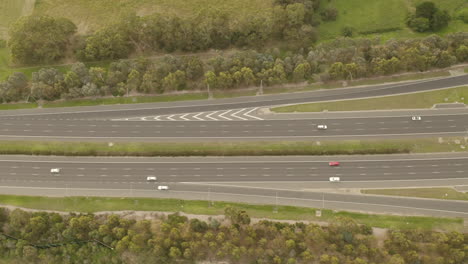 aerial perspective drone tracking cars traveling along modern highway arterial