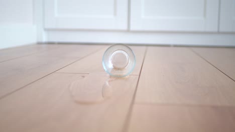 spilled glass of water on wood floor