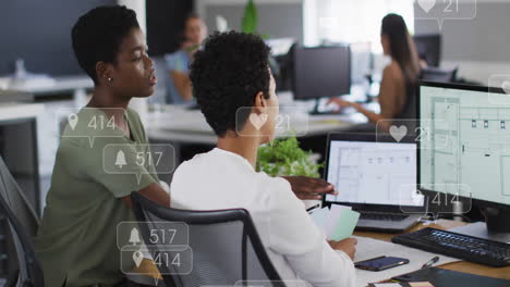 Animation-of-multiple-notification-bars-over-diverse-female-coworkers-discussing-reports-on-computer