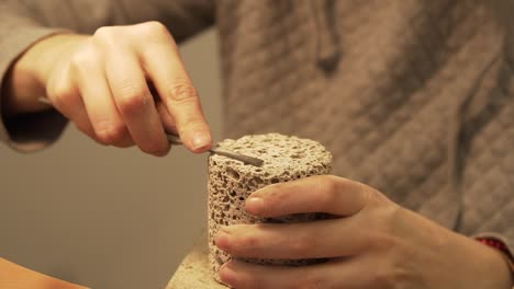 Cleaning---filing-of-cylinder-from-concrete---closeup-shot-in-slow-motion