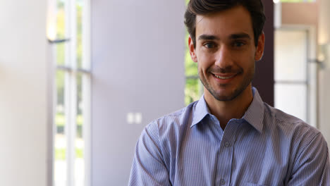 Male-business-executive-standing-with-arms-crossed-in-office-4k