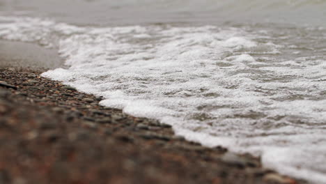 Waves-in-slow-motion-hitting-the-rocky-shore-and-crashing-with-power