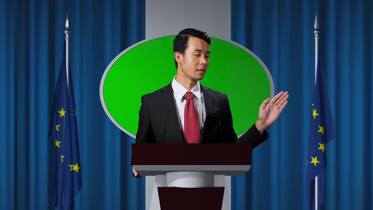 Asian Portrait Of Organization Representative Speaking At A Press Conference In Government Building With Mock Up Green Screen, Press Officer Delivering A Speech At A Summit. Backdrop With Eu Flags
