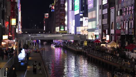 illuminated urban canal with passing boats