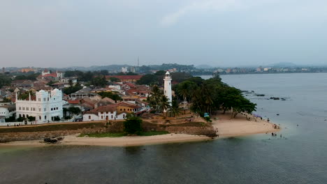 aerial drone of galle fort lighthouse at sunset golden hour