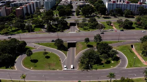 aerial flight over a highway interchange in a large city with looping entrance and exit ramps