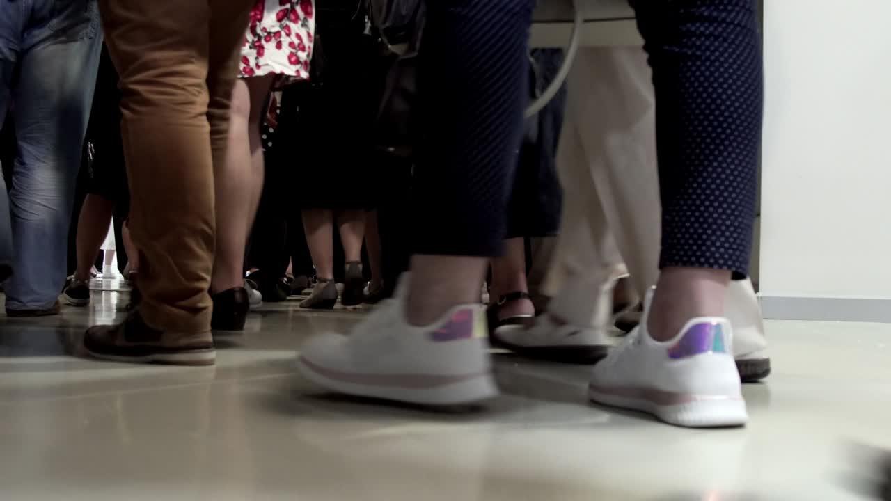 Walking people crowd legs move out of underground metro station after announcement for terrorist attack