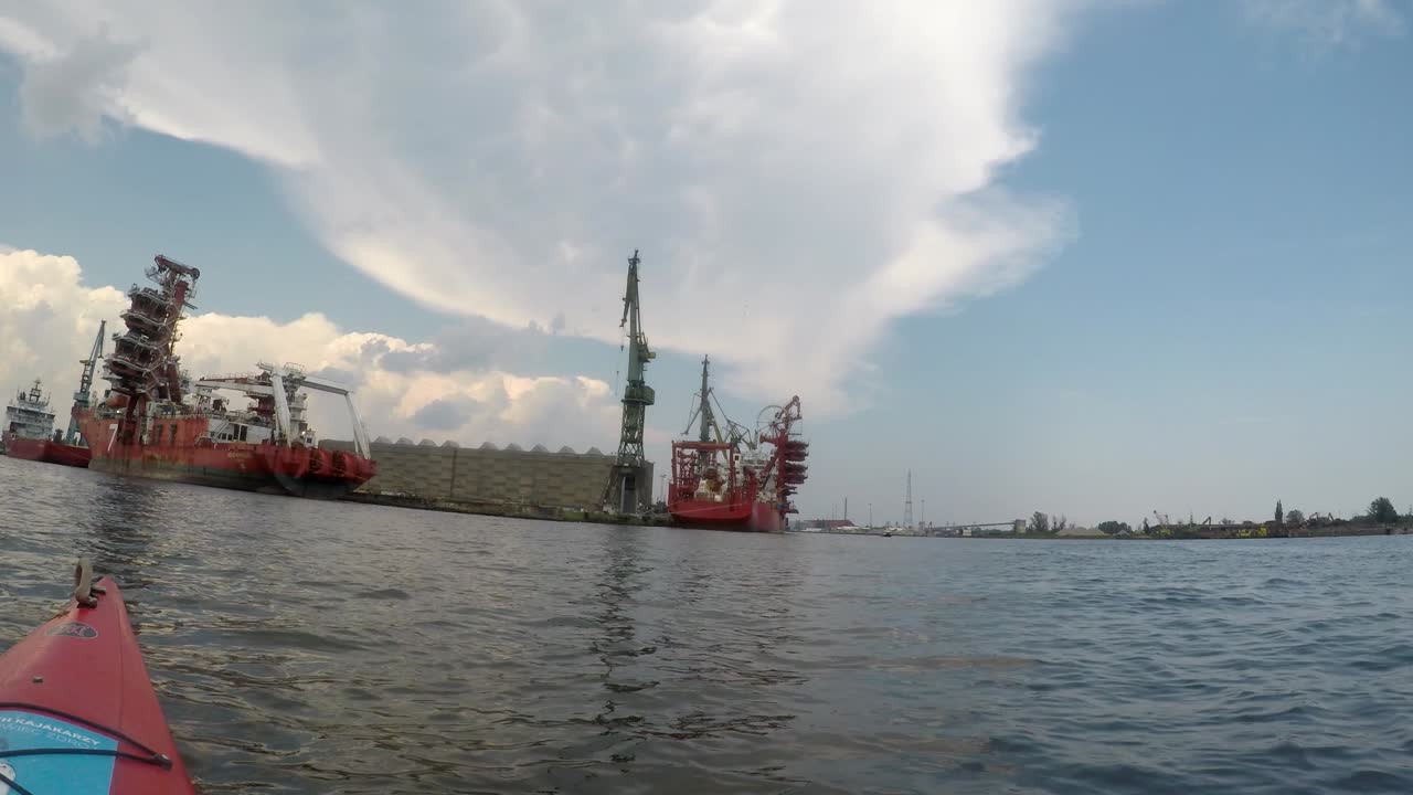 Ships and crane in Gdańsk shipyard seen from kayak