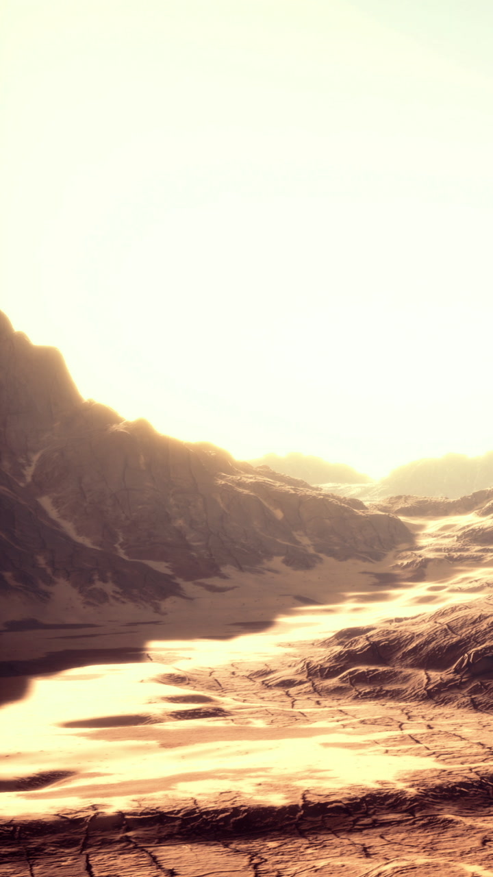 Sunrise over desert landscape with mountains and dry ground