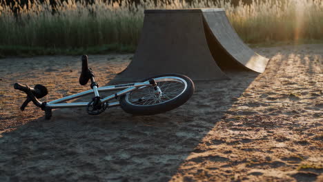 abandoned bmx bike at a skate park at sunset
