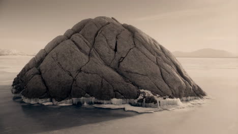 ancient rock formation in a vast frozen landscape