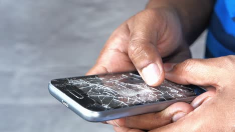 person using a cracked smartphone