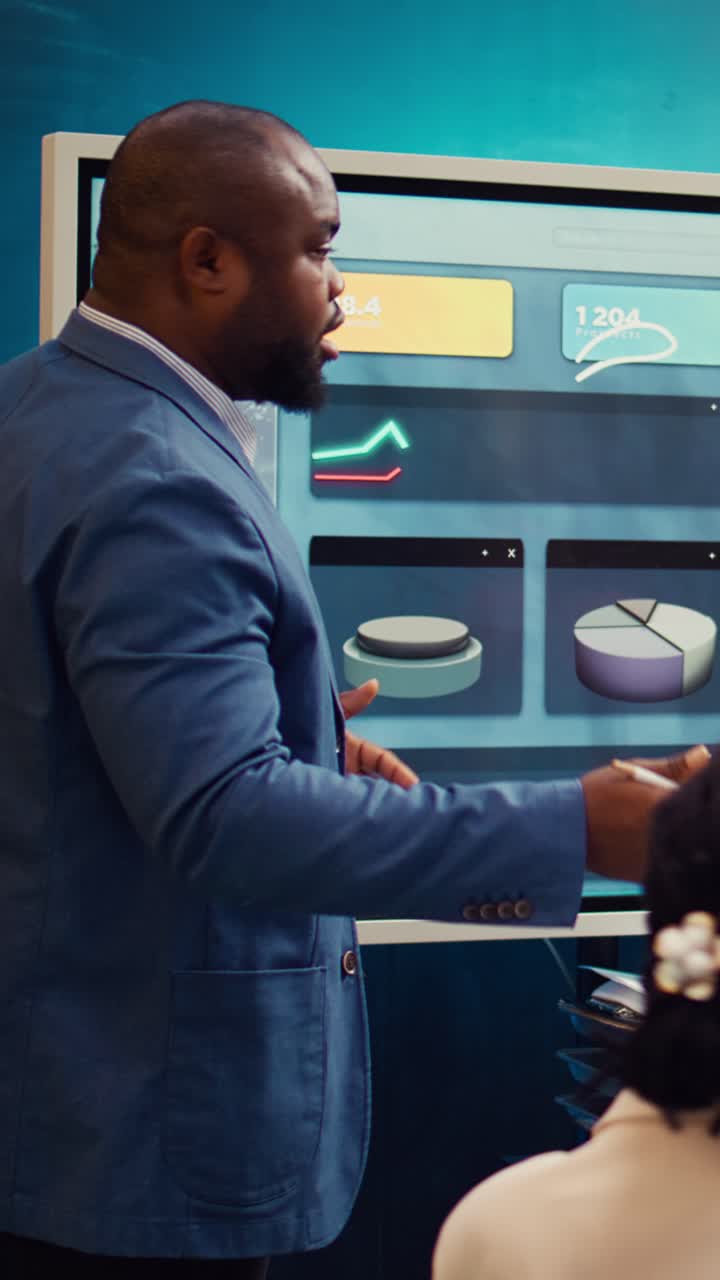 African American Businessman Presenting Data on Interactive Screen