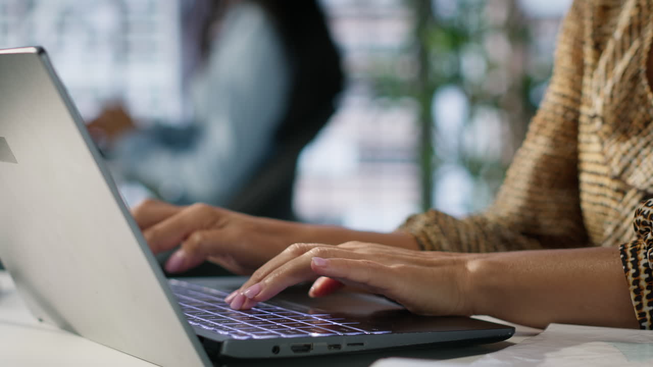 Woman typing on a laptop