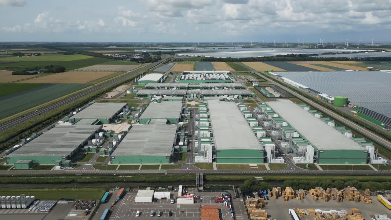 Expansive drone shot showing the full scale of a data center complex at Eemshaven, used for cloud platforms, big data processing, and AI infrastructure