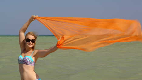 woman with pareo waving in the wind