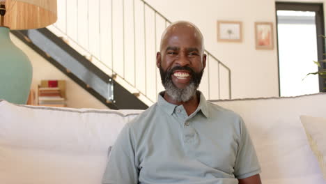 African-American-senior-man,-smiling,-sitting-on-couch