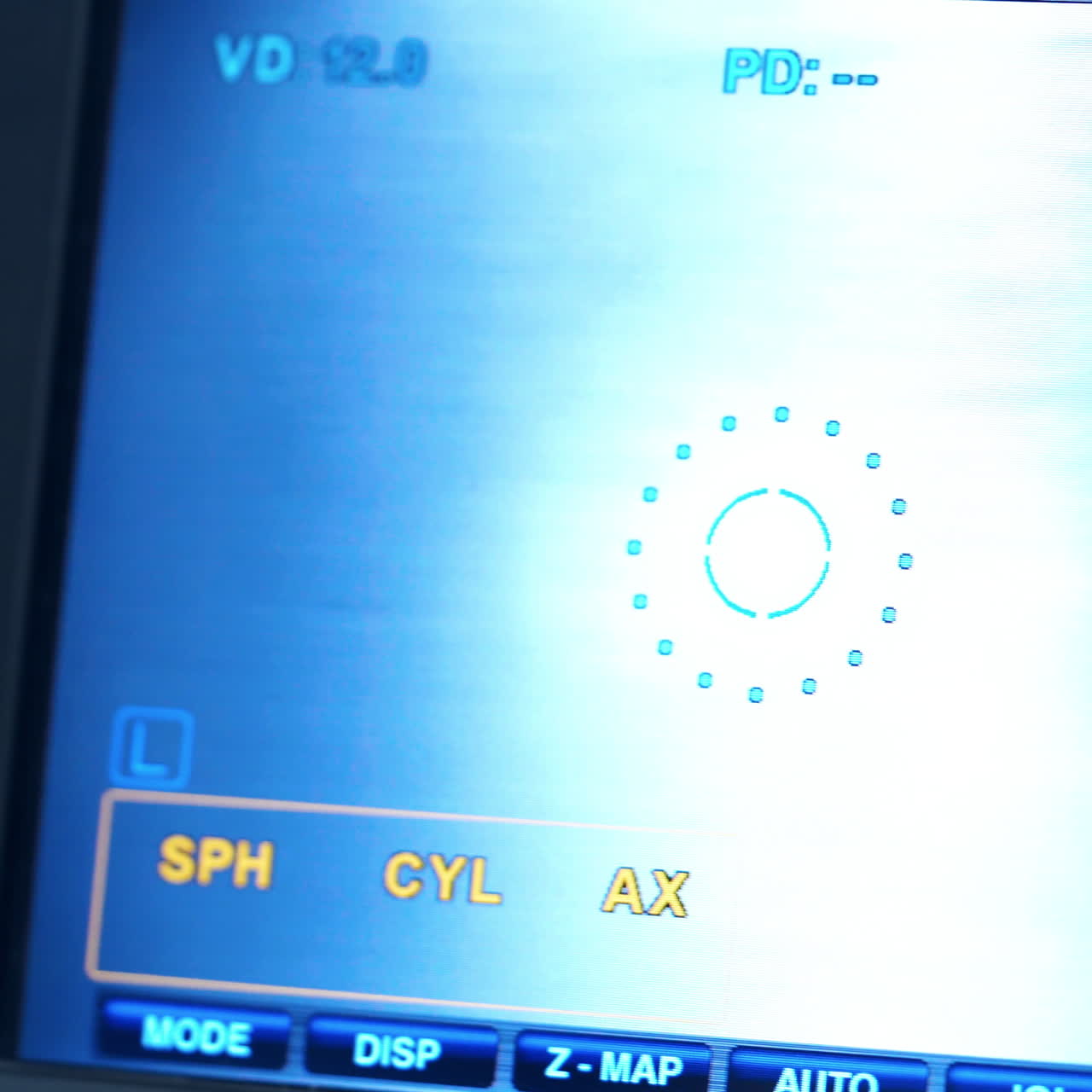 Refractometer machine. Patient testing eyes in clinic. Screen showing progress of eye examination. Close-up.