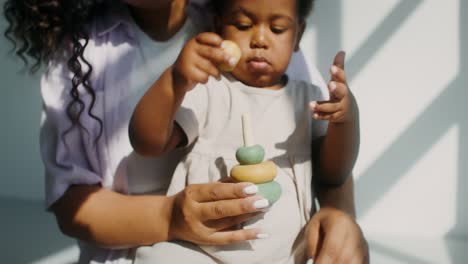 mother and daughter playing with stacking toys