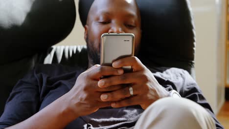 man using mobile phone in a comfortable home 4k