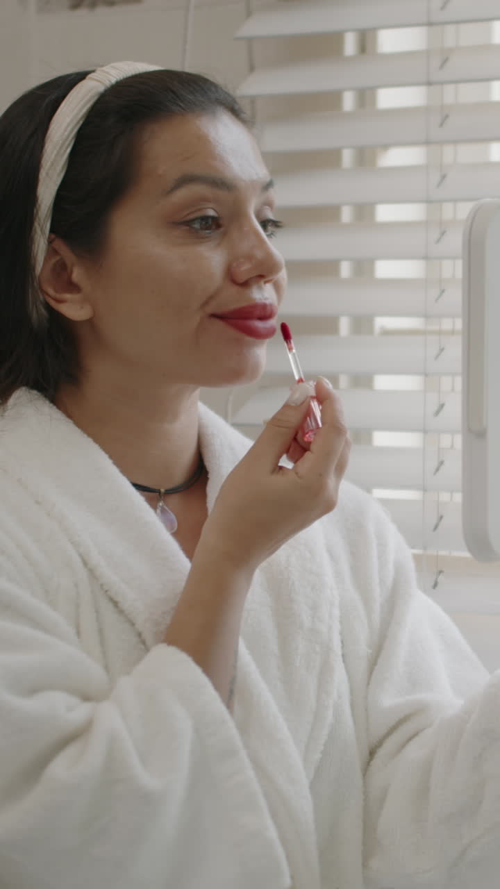 Millennial Woman Applying Red Lipstick Getting Ready for Date