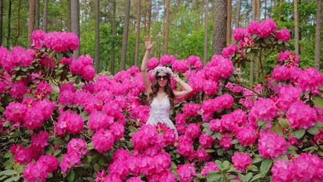 feminine power and spring rebirth shown in slow motion dance, pink rhododendrons
