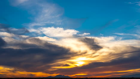 epic sunset over the rugged wilderness of the mojave desert with the sky blooming in colorful transitions - wide angle time lapse