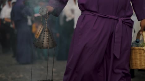Devotee-Swings-Thurible-During-Holy-Week-Procession-In-The-Streets-Of-Antigua,-Guatemala