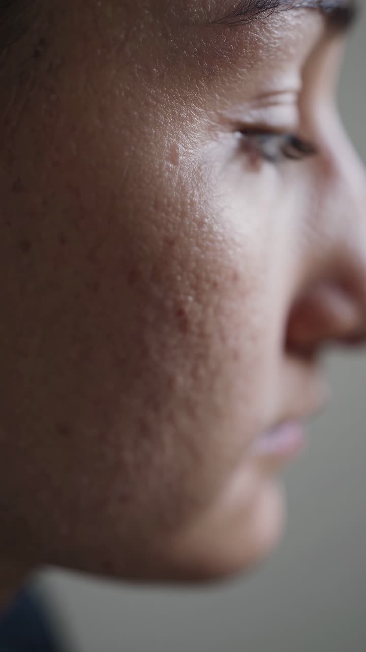 Close-up side profile of a person's face, highlighting skin texture