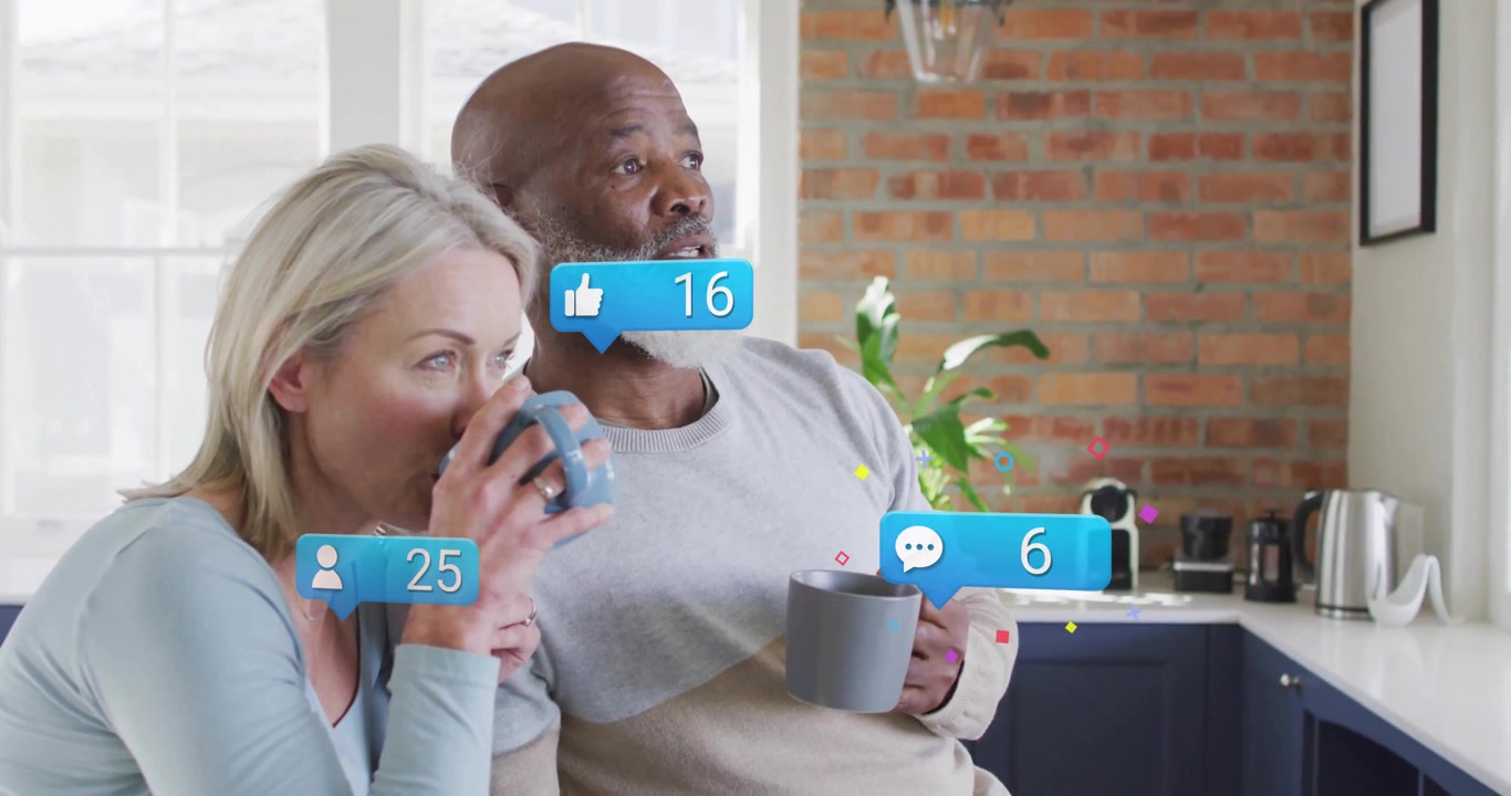 Couple sipping coffee at kitchen counter and initiating social media icons floating around heads