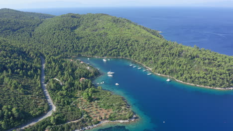 aerial: panoramic drone shot of beautiful panormos bay in skopelos island, sporades, greece