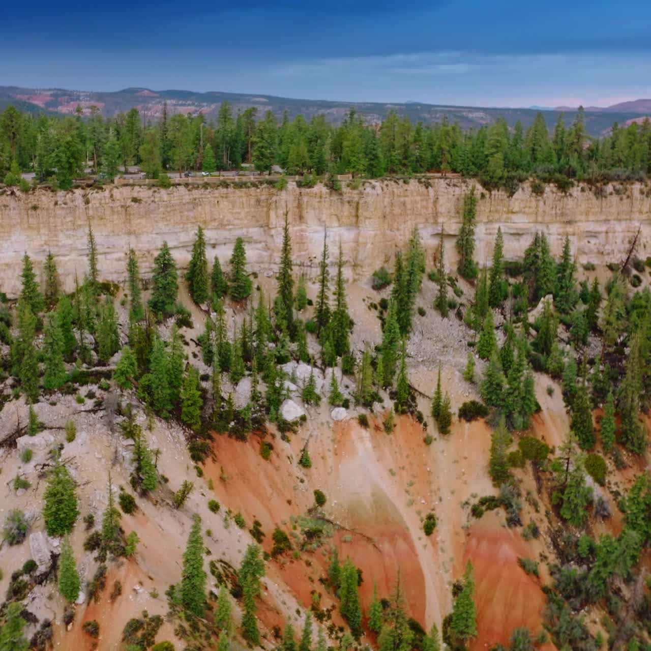Delightful sight of beautiful cliffs overgrown with pine trees. Amazing mountains and blue skies at backdrop