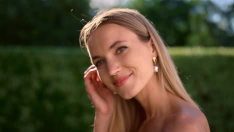 attractive woman looking at camera. young lady touching hair with hand