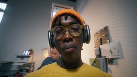 young man listening to music in an office