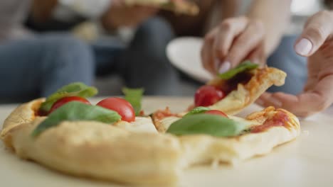 Detailed-video-of-human-hands-taking-a-slice-of-pizza