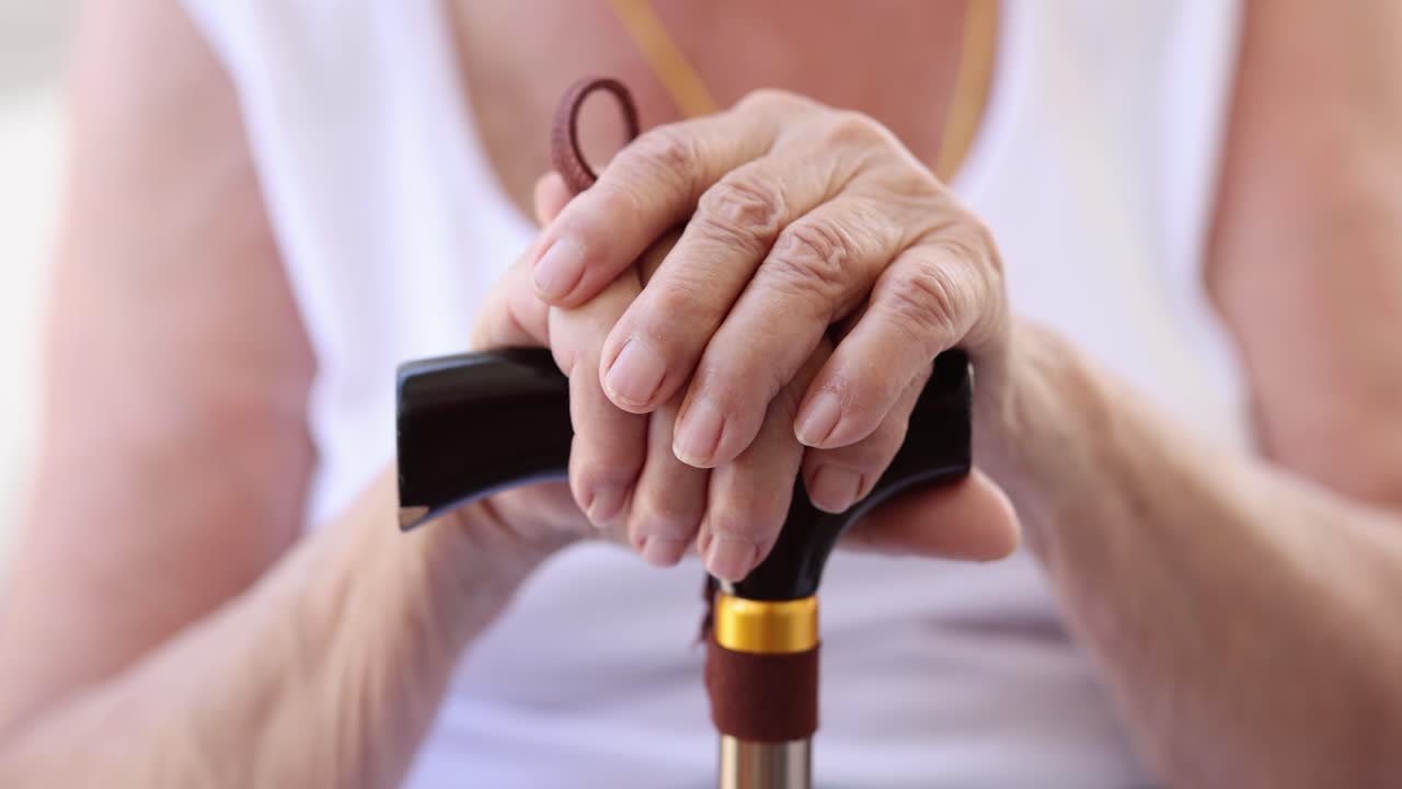 Close up of Elderly Hands on Cane