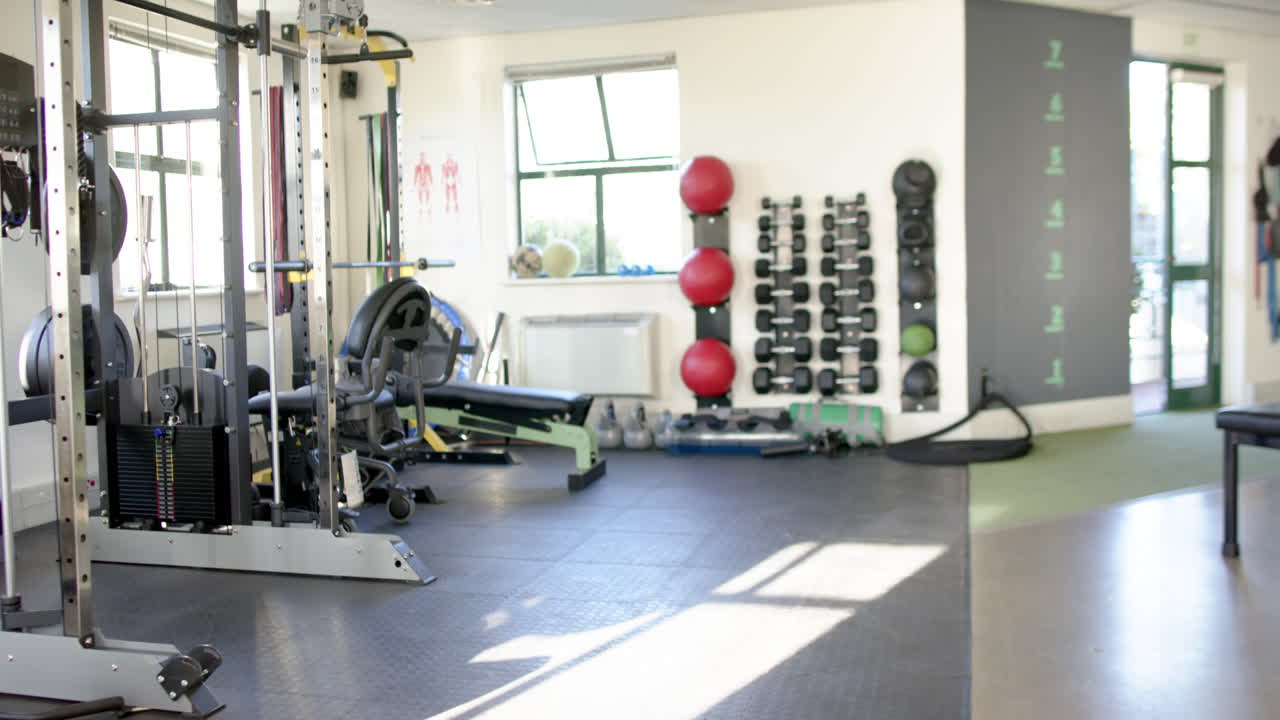 In rehabilitation center gym, exercise equipment used for disability rehab therapy, copy space