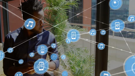 animation of network of connections over biracial man using smartphone