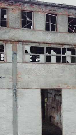 aerial view of abandoned industrial buildings. drone flies over an abandoned factory.. vertical video