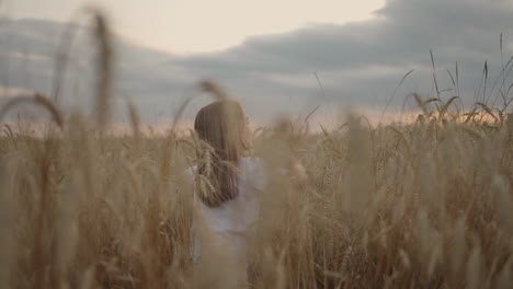 daughter and mother dream together run in the wheat field at sunset. happy family people in the wheat field concept. mom and girl playing catch-up run. baby child fun running in green meadow.