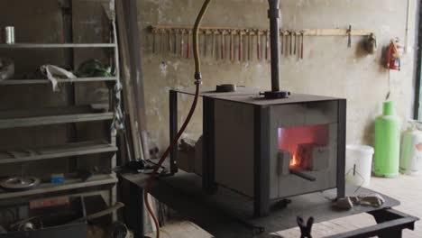 Close-up-of-kiln-and-tools-on-table-in-workshop